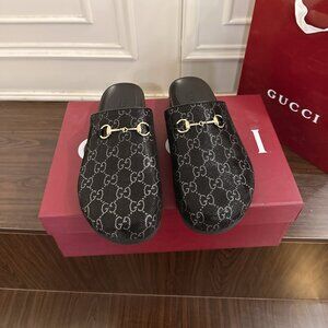 Gucci Black Mules with Gold Accents